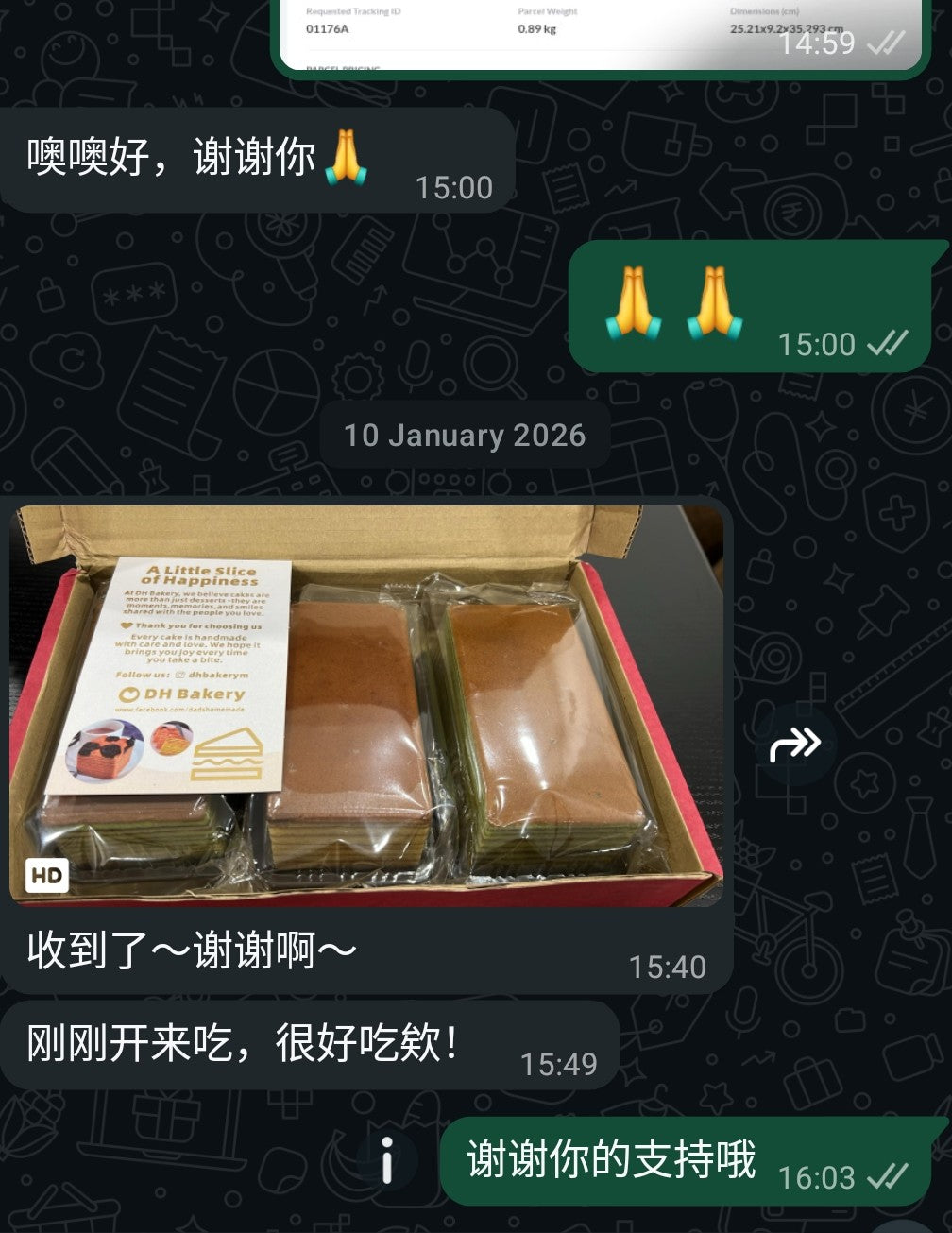 Box of packaged layer cake slices with thank you card on a table, WhatsApp chat overlay